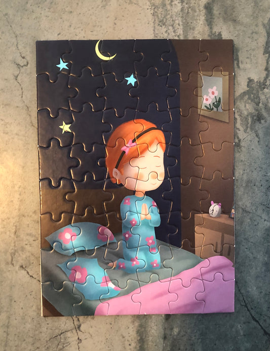 Children's prayer jigsaw puzzle featuring a girl in pajamas praying by her bedside